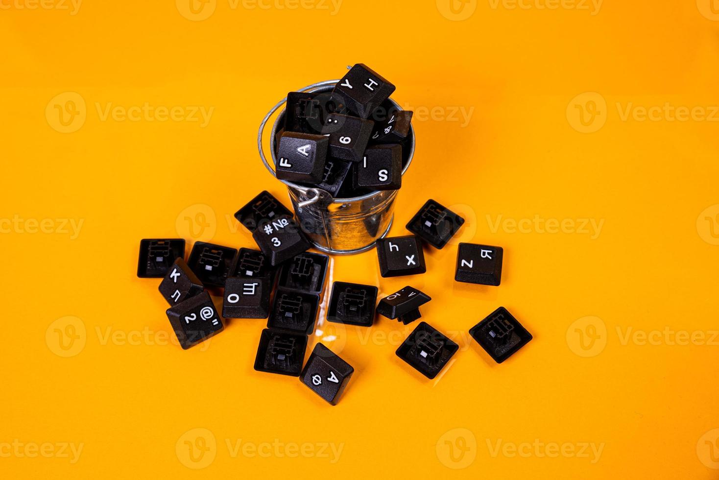 keyboard button in glass in jar in bucket on orange background photo