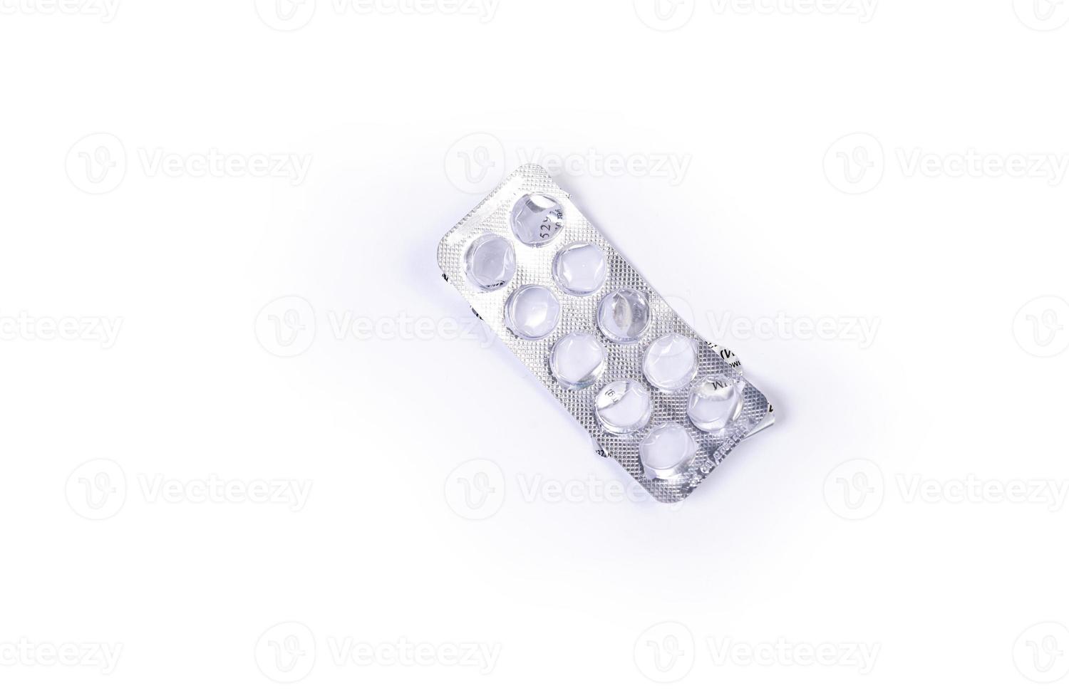 Medical pill blister on isolated white background with reflection photo