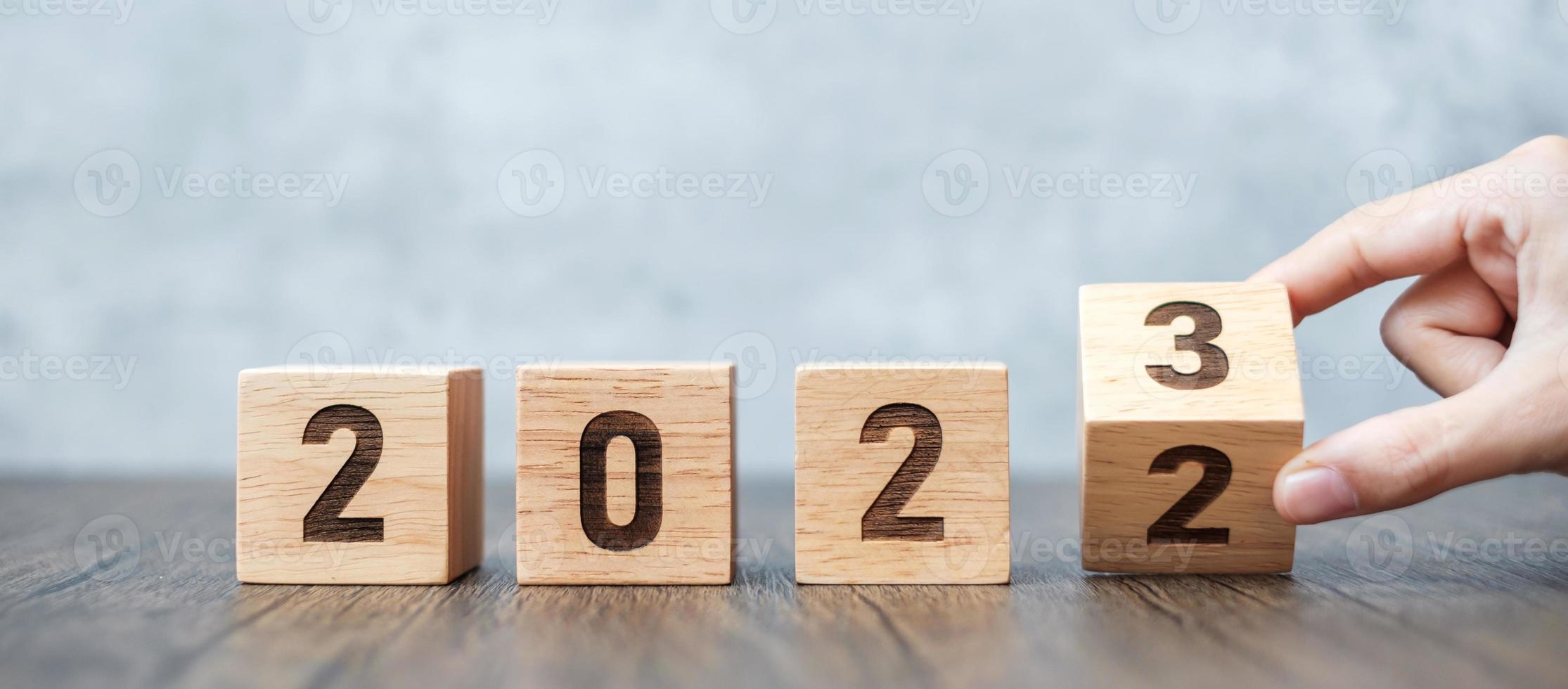 hand flip 2022 to 2023 block. goal, Resolution, strategy, plan,, motivation, reboot, forecast, change, countdown and New Year holiday concepts photo