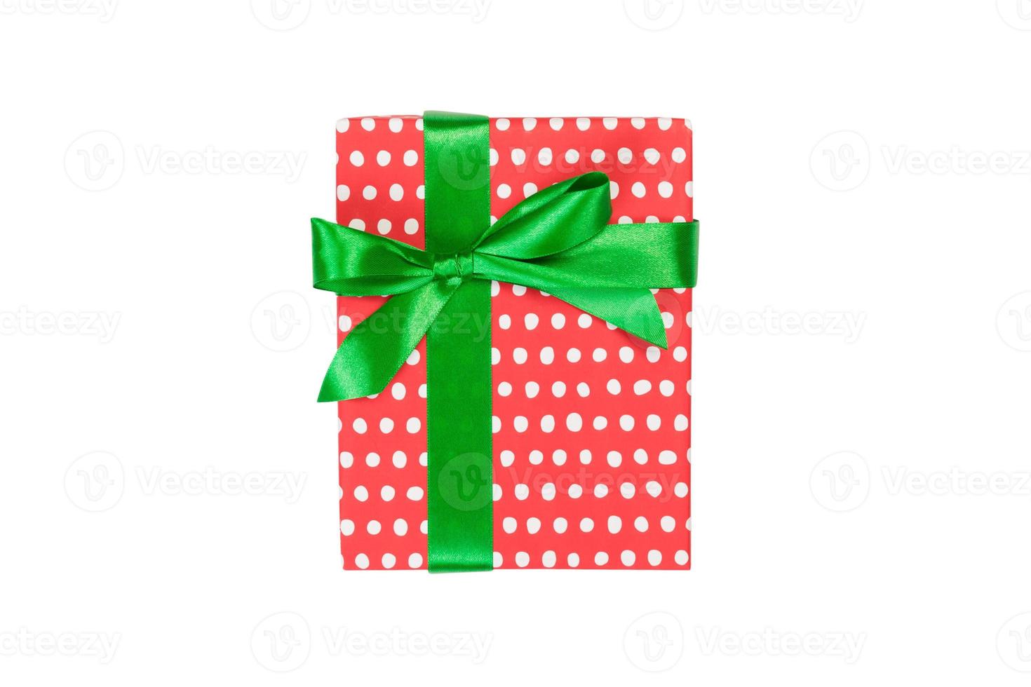 Christmas or other holiday handmade present in red paper with Green ribbon. Isolated on white background, top view. thanksgiving Gift box concept photo