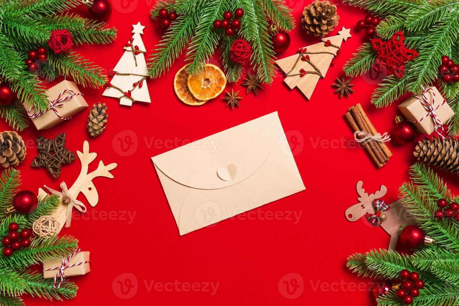 Top view of envelope on red background. New Year decorations. Christmas holiday concept photo