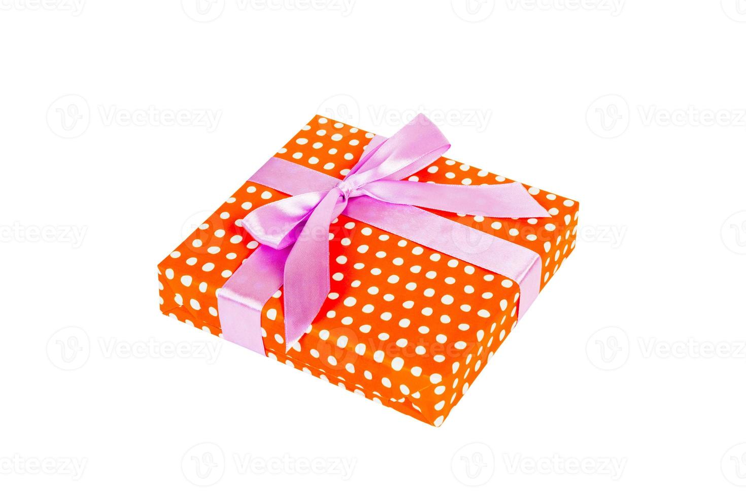 Christmas or other holiday handmade present in orange paper with purple ribbon. Isolated on white background, top view. thanksgiving Gift box concept photo