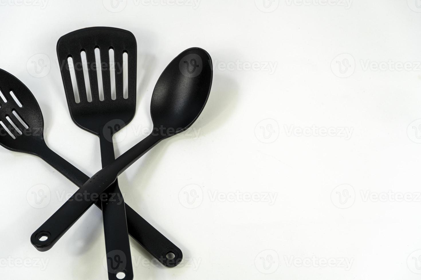 black plastic kitchen utensils isolated on white. Clipping path included. mexico photo