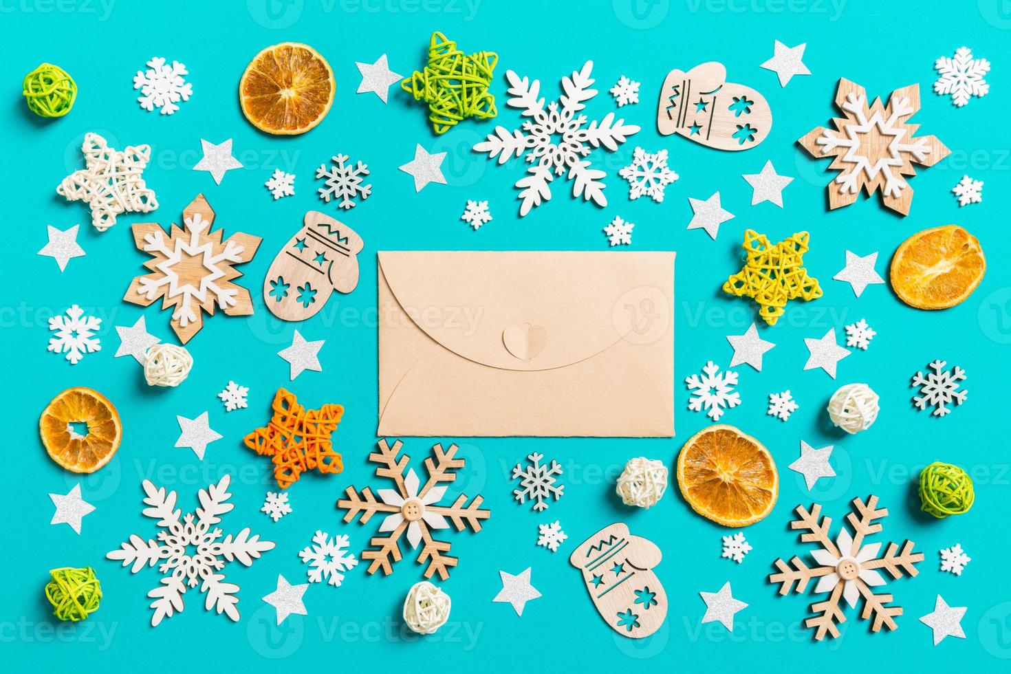 Top view of craft envelope on blue background with New Year toys and decorations. Christmas time concept photo