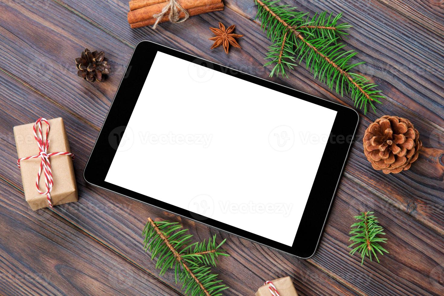 Digital tablet mock up with rustic Christmas wooden background decorations for app presentation. top view with copy space photo