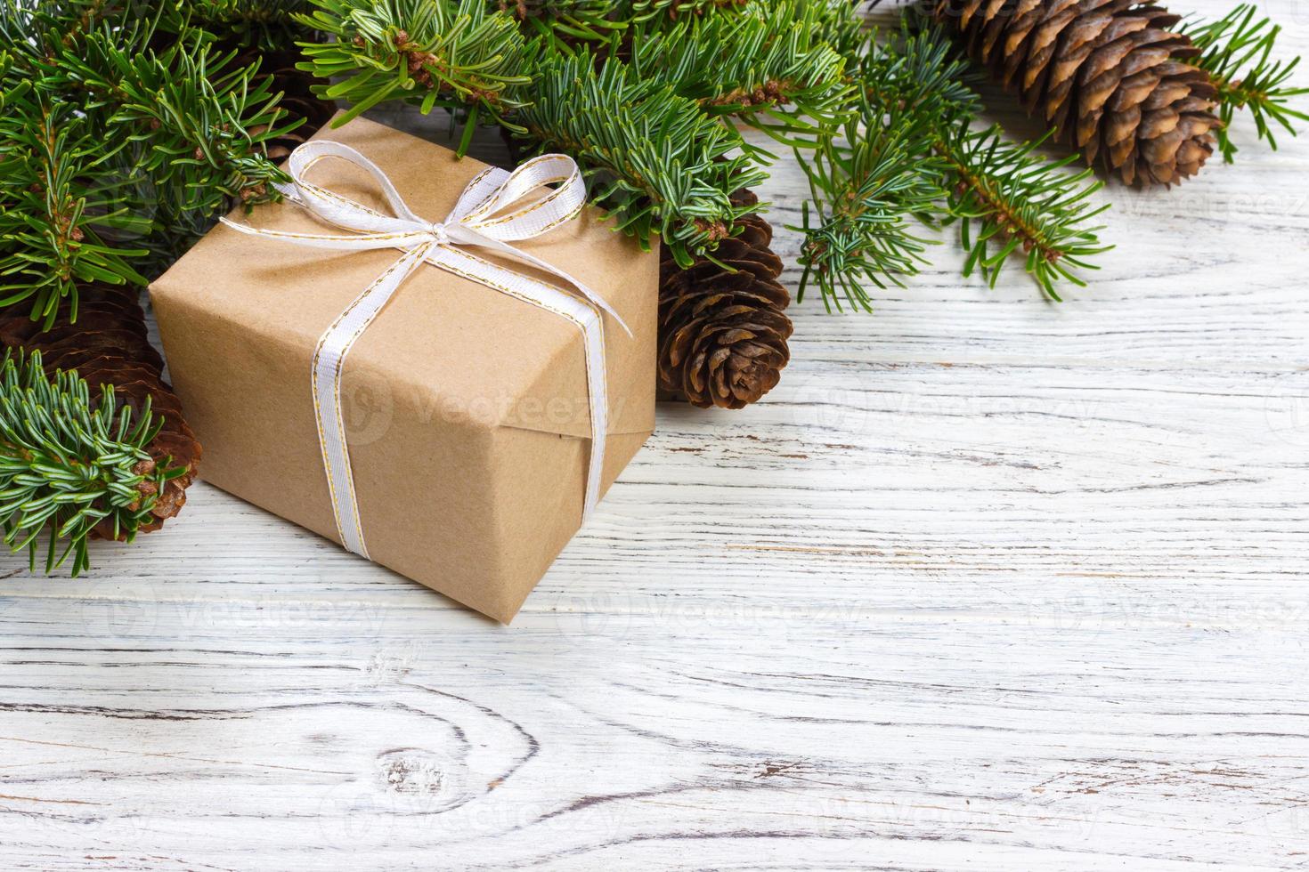 Christmas background with Christmas gift on wooden background with Fir branches. Xmas and Happy New Year composition. top view photo