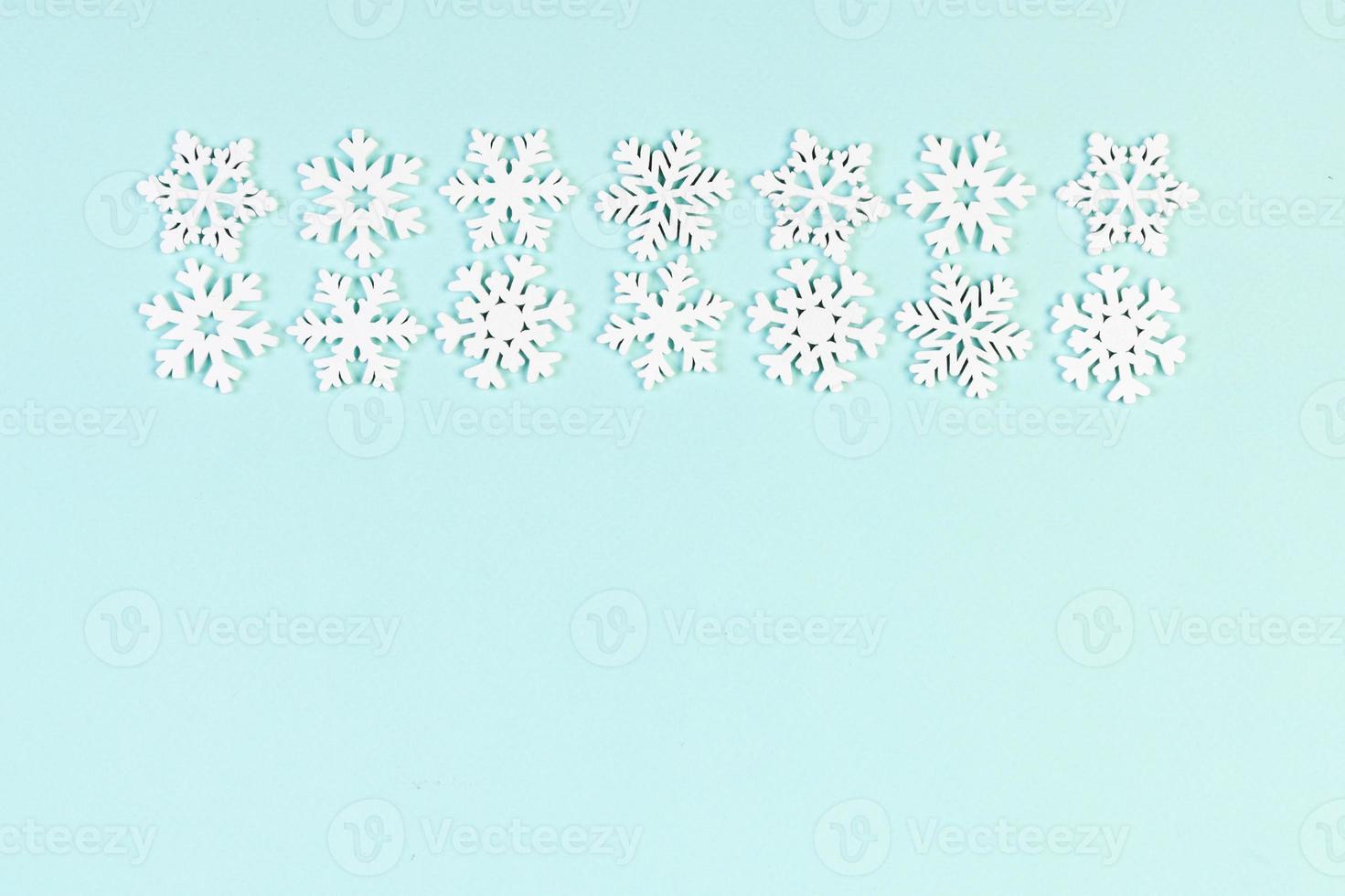 Set of white snowflakes on colorful background. Top view of Christmas ornament. New Year time concept with empty space for your design photo