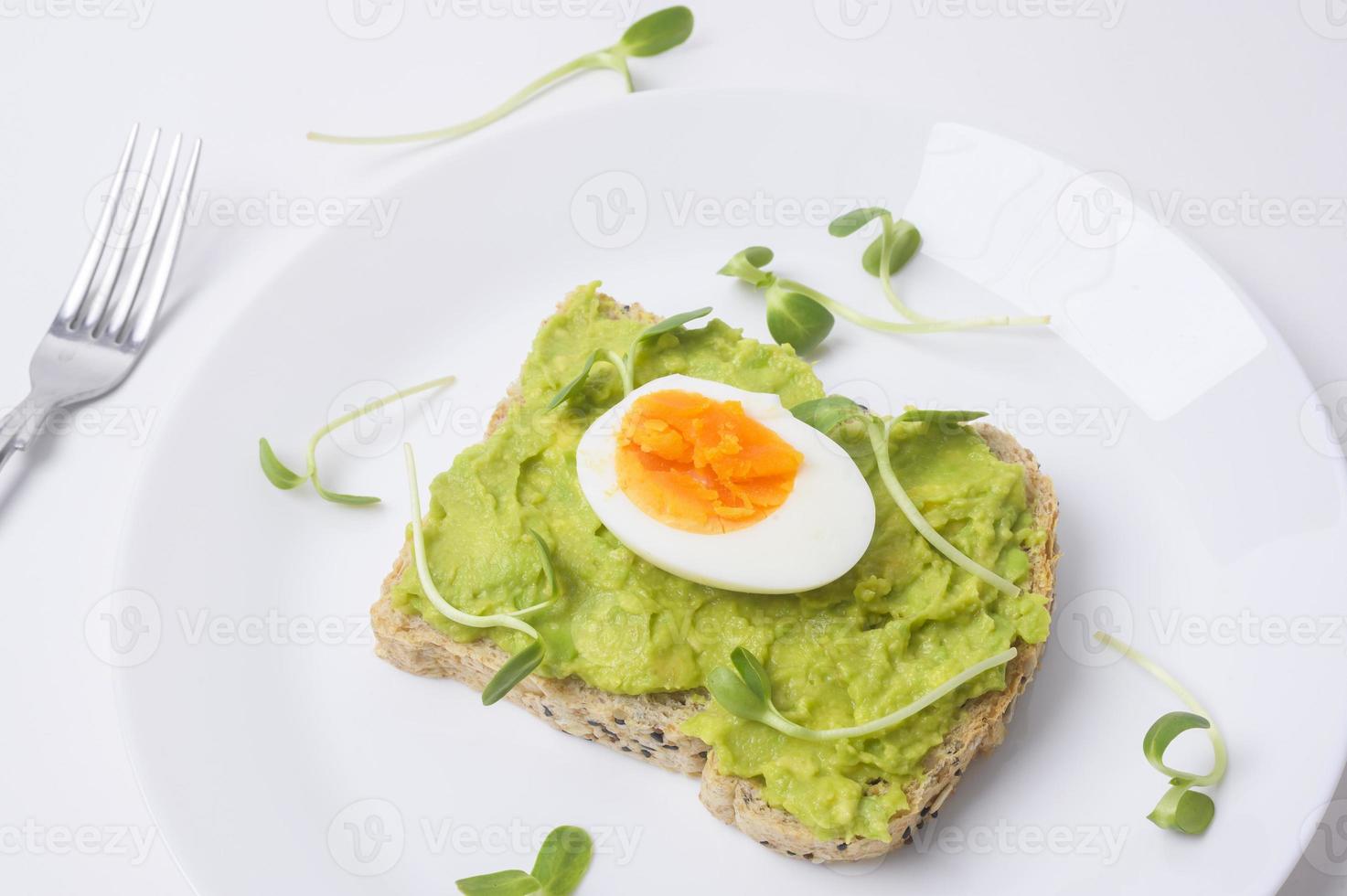 Bread with avocado , vegetables fruit and egg on white background , Healthy breakfast concept photo