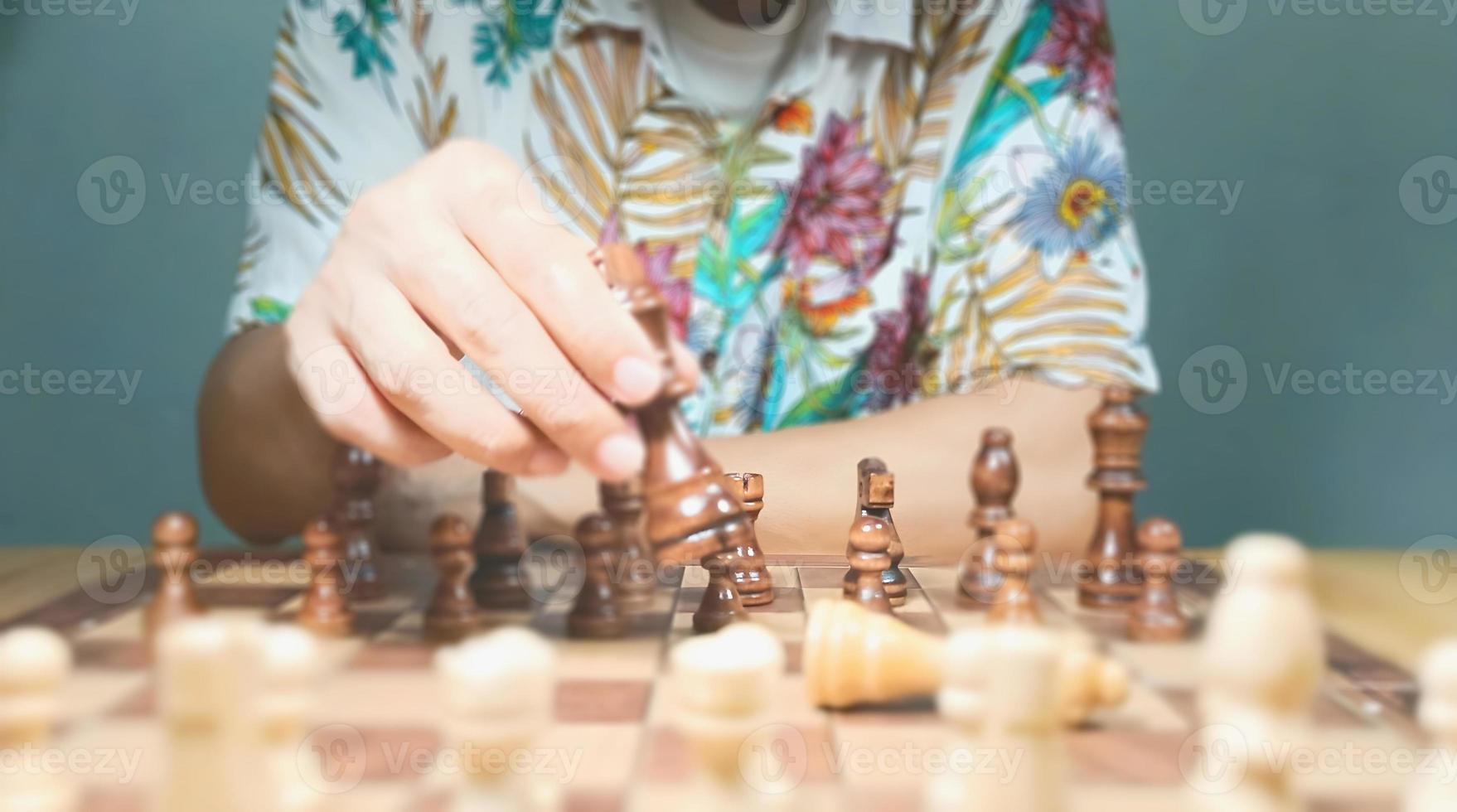 Man play game of chess shows a strong will to plan and fight on the field to defeat your opponents. Pictures show different time periods. from start to finish and predict the descent of the winner. photo