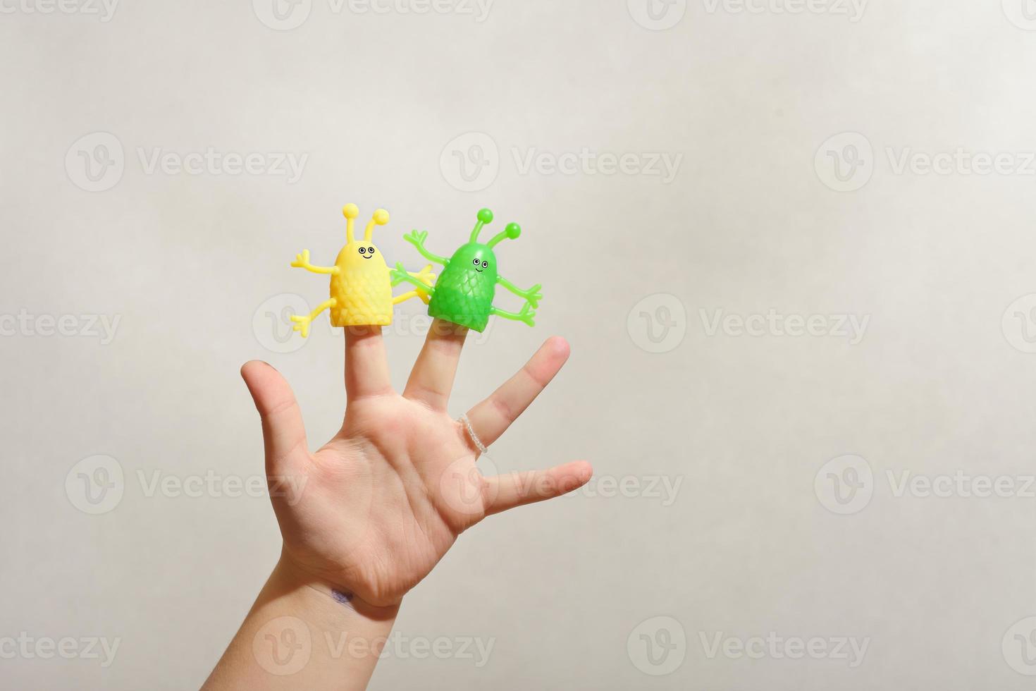 two fingers wearing puppets aliens. Kid playing fingers puppets. Finger theater for children photo