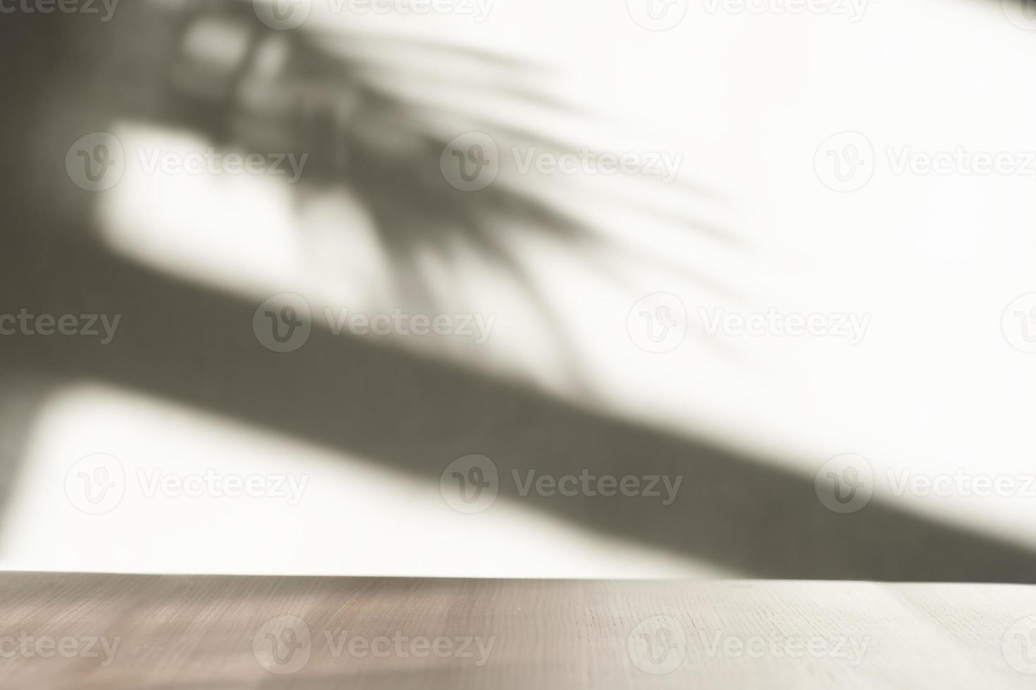 empty scene with wooden table and palm shadows on the wall. product presentation design and promotion for new packaging. copy space for display or mockup photo