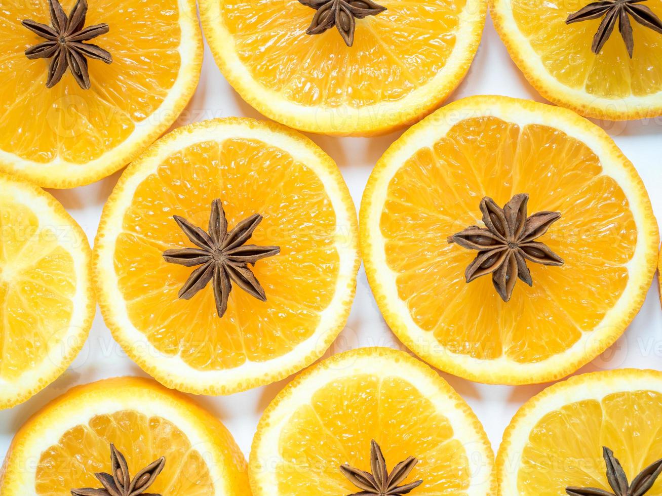 Abstract background with citrus fruit of orange slices and star anise. photo