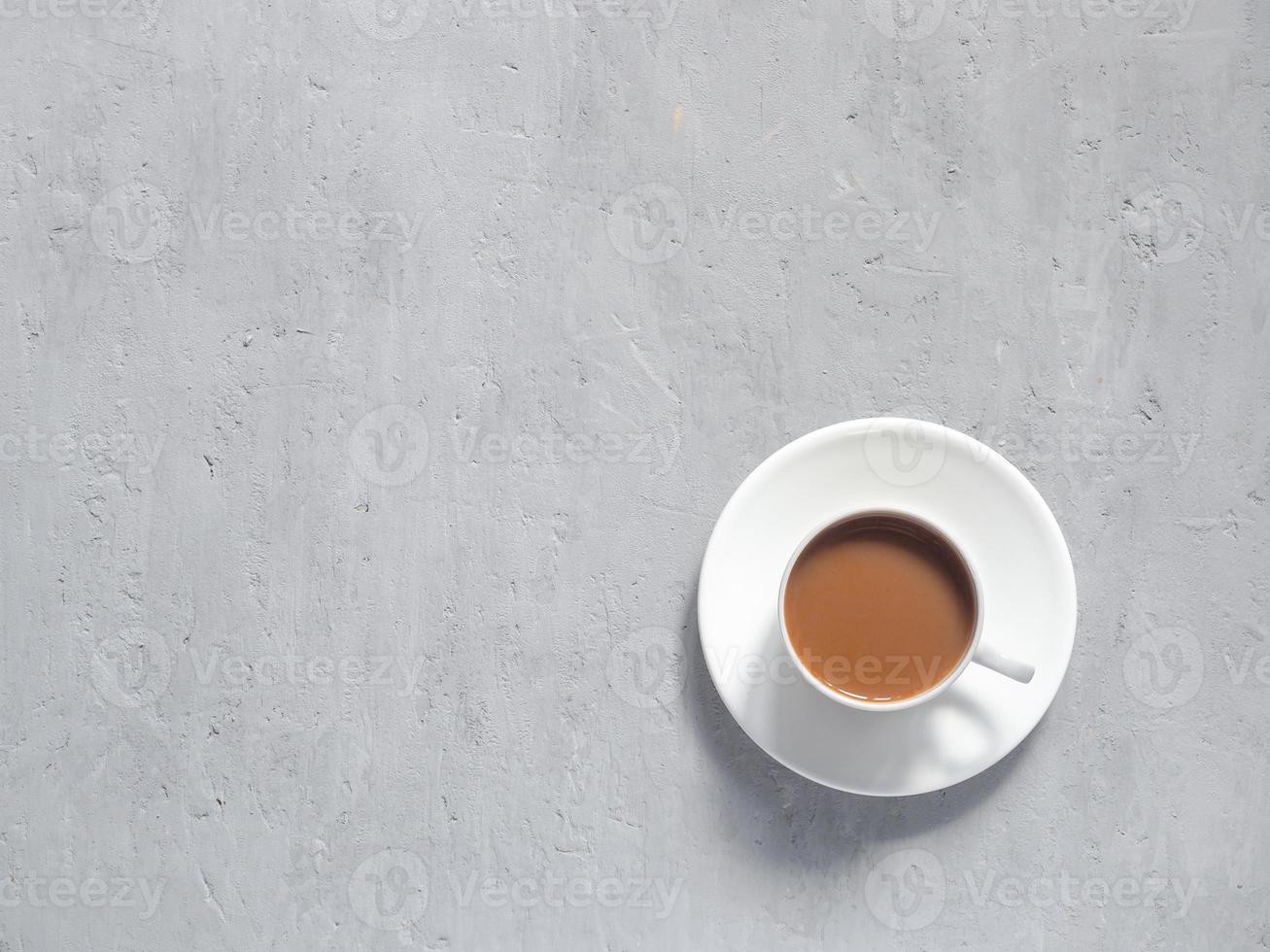 taza de café fragante sobre un fondo bajo el hormigón. el minimalismo es la vista desde arriba. copie el espacio foto