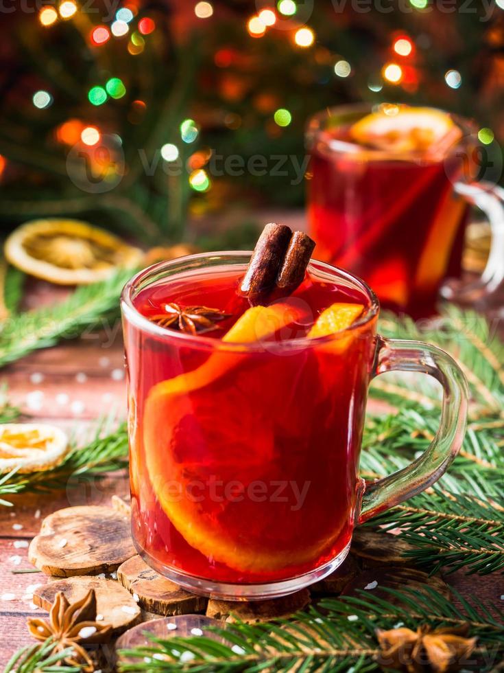 Christmas mulled wine with oranges and spices Christmas decorations with bokeh photo