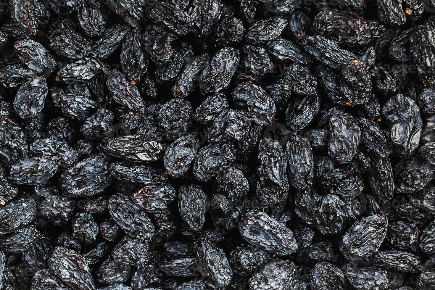 Black Raisin texture, popular dried fruit. Dried grapes. photo