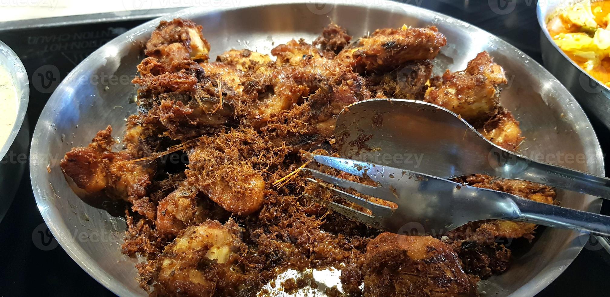 Ayam goreng rempah or traditional Javanese fried chicken, cooked on frying pan photo