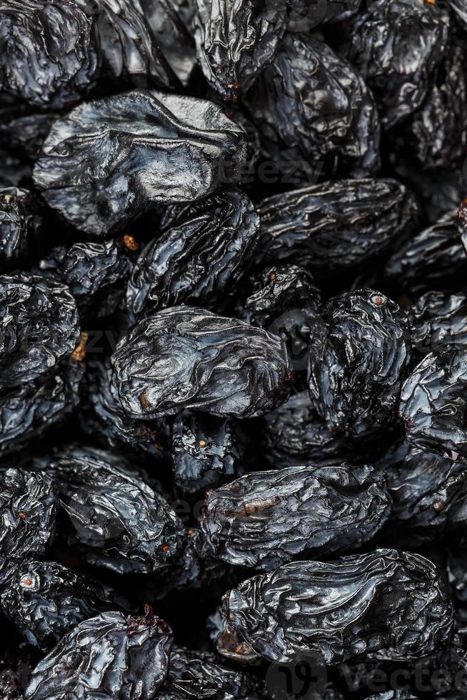 Black Raisin texture, popular dried fruit. Dried grapes. photo