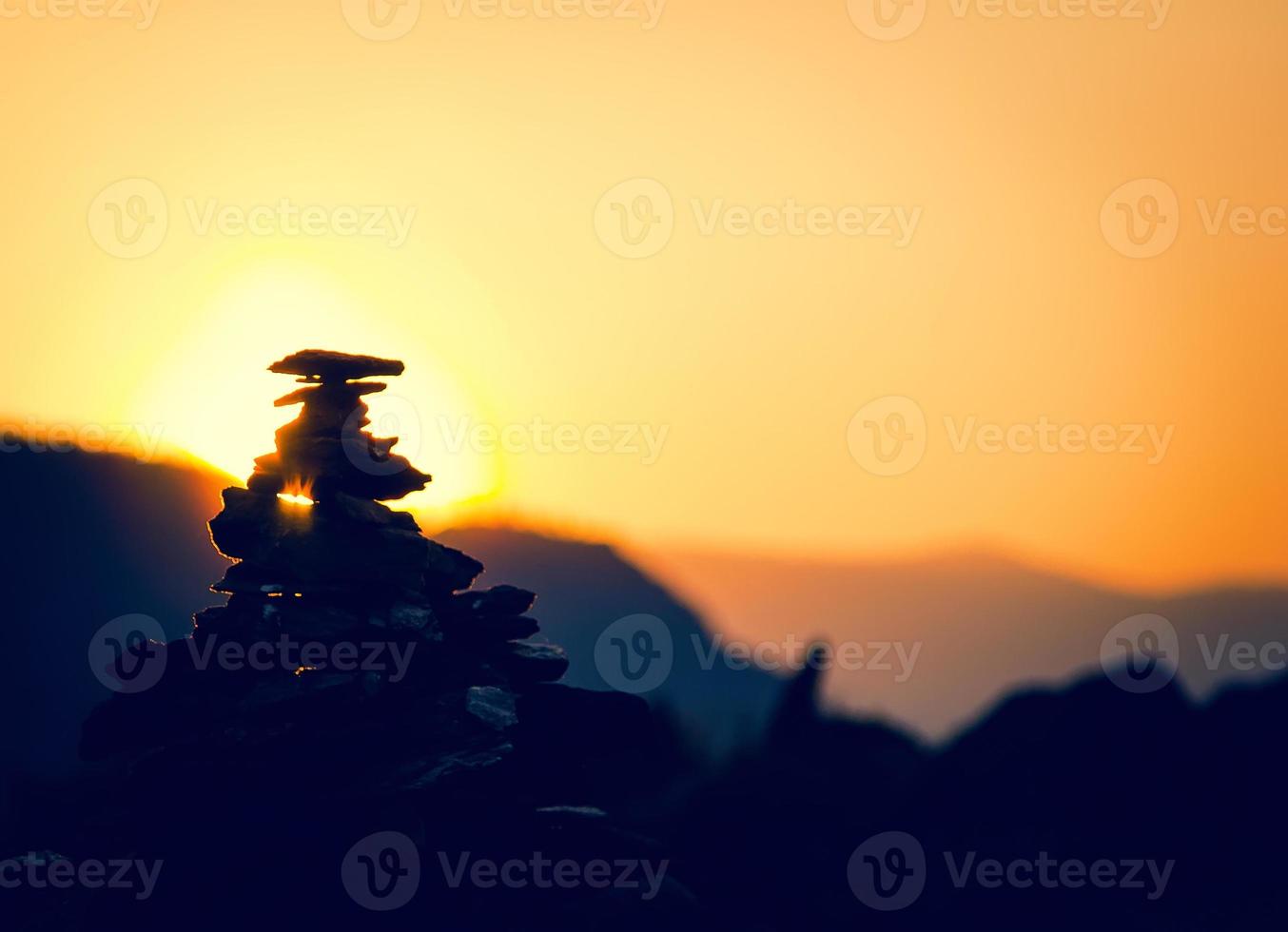 Spa stones balance, colorful summer sky background, silhouette of stacked pebbles and butterfly, beautiful nature, peaceful beach sunset, conceptual image of stable life photo