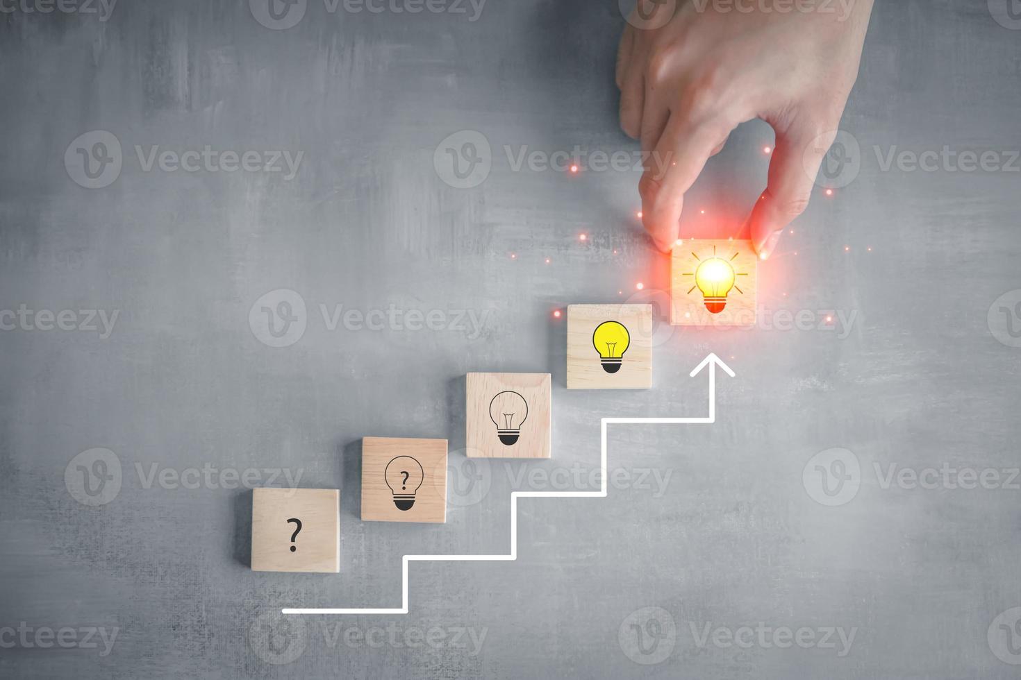 Idea and creativity concept. Creative process concept and problem solution. Hand pick glowing light bulb from step of question mark on stair to glowing light bulb for solving problem. photo