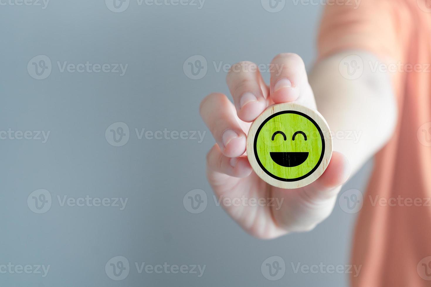 Feedback rating and service review. Customer experience, Mental health assessment, World mental health day, Think positive, Emotion, Satisfaction. Hand showing green happy smile face. photo