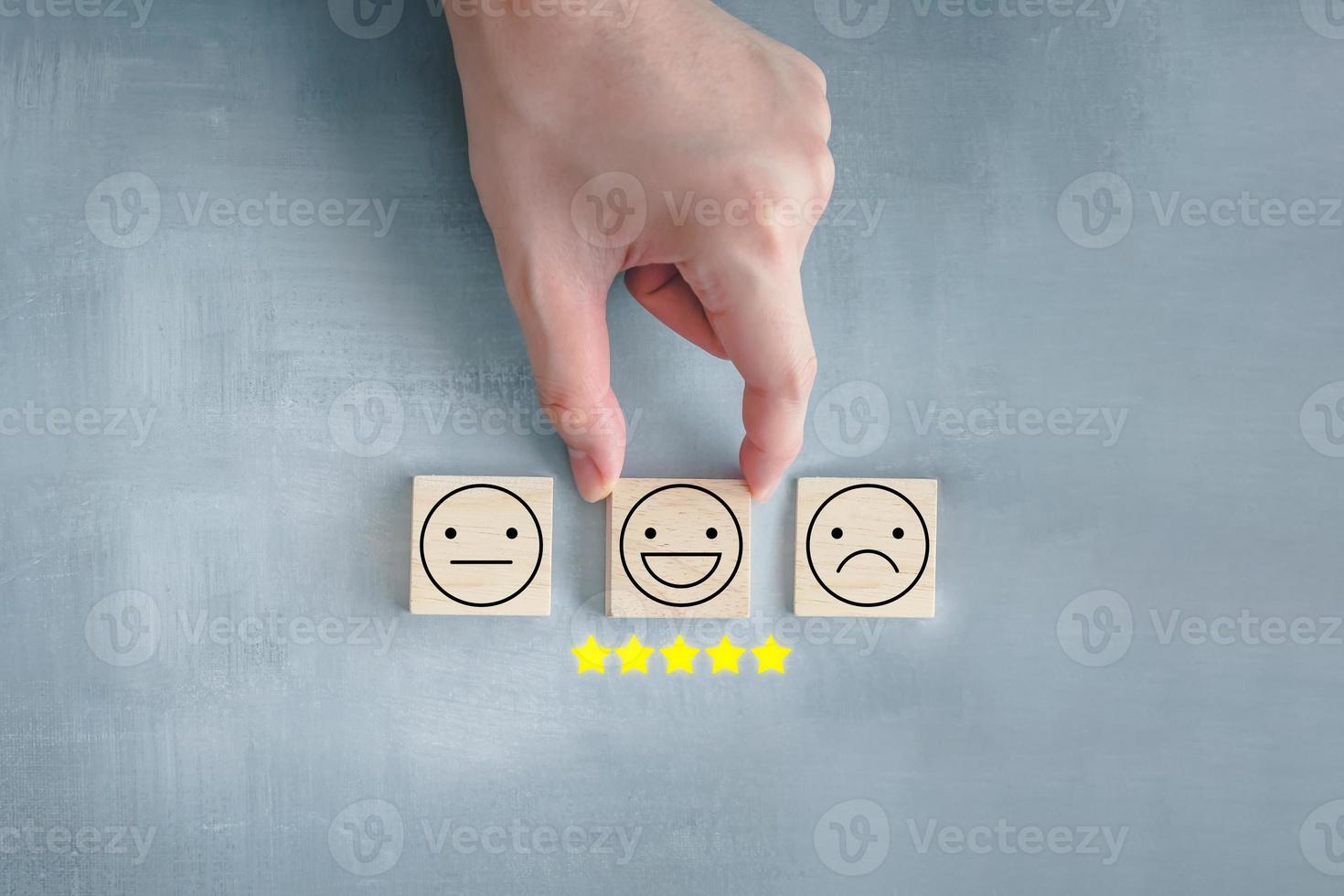 Emotion, Think positive, World mental health day, Mental health assessment, Satisfaction survey, Feedback rating and positive service review. Customer experience. Hand choosing happy face with 5 star. photo