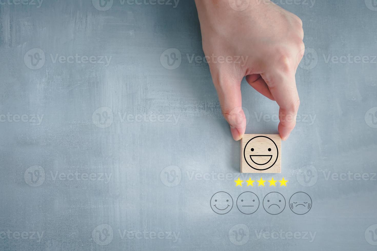 Feedback rating and positive service review. Customer experience, Think positive, Emotion, World mental health day, Mental health assessment, satisfaction survey. Hand choosing happy face with 5 star. photo