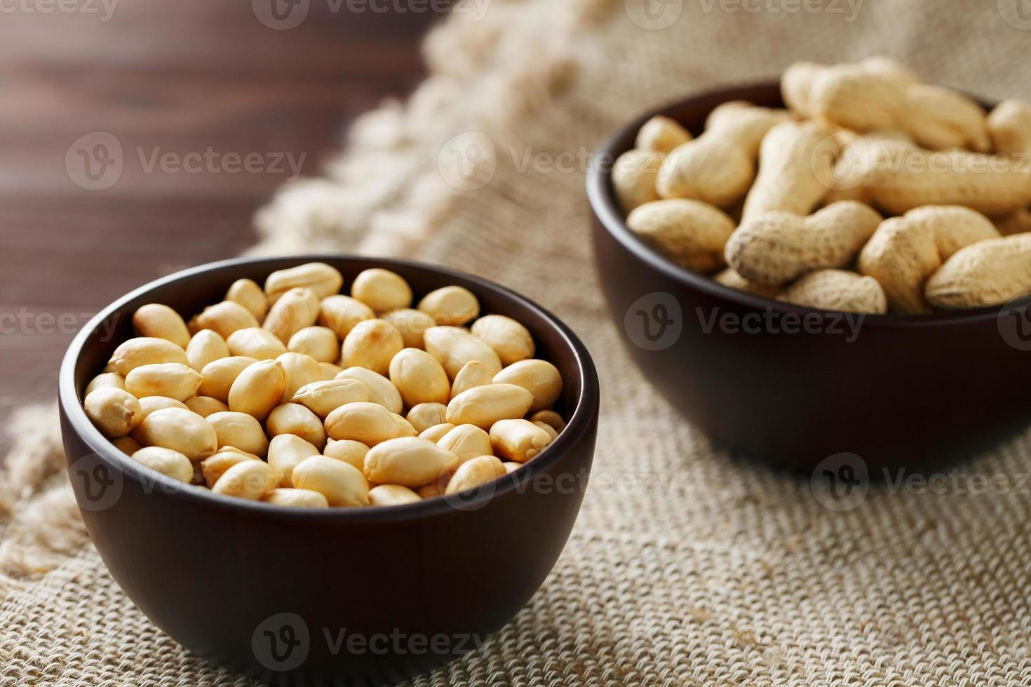 Peanuts in the shell and peeled closeup in a cup photo