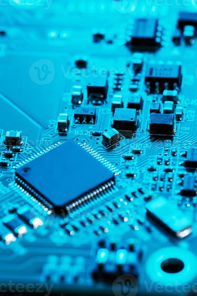 Electronic circuit board close up. Processor, chips and capacitors. photo