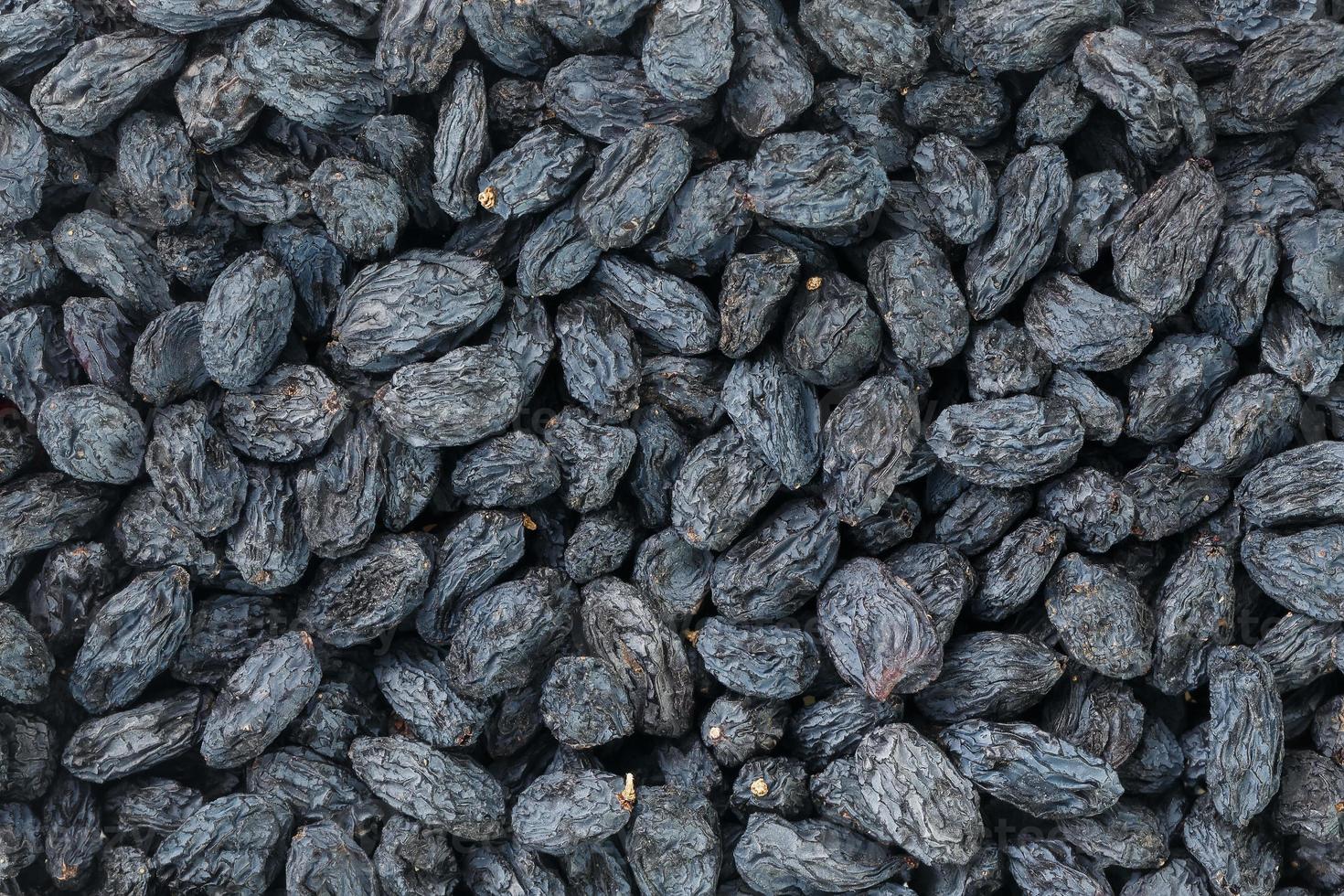 Black Raisin texture, popular dried fruit. Dried grapes. photo