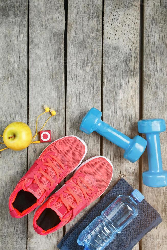 Composition with sport shoes on wooden background photo