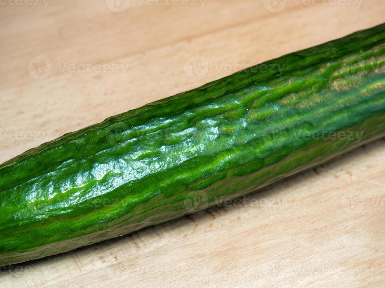 Smooth medium cucumber. Cucumber on a cutting board.  Fresh ripe vegetable photo