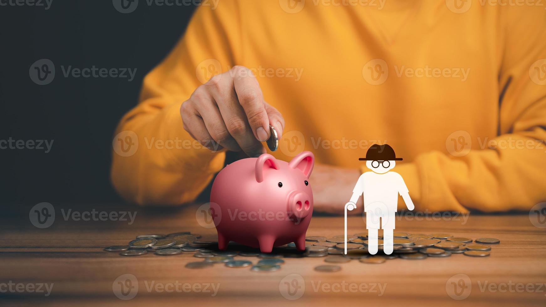 Man putting coin into piggy bank for saving money, retirement, health care, business finance and investment. photo