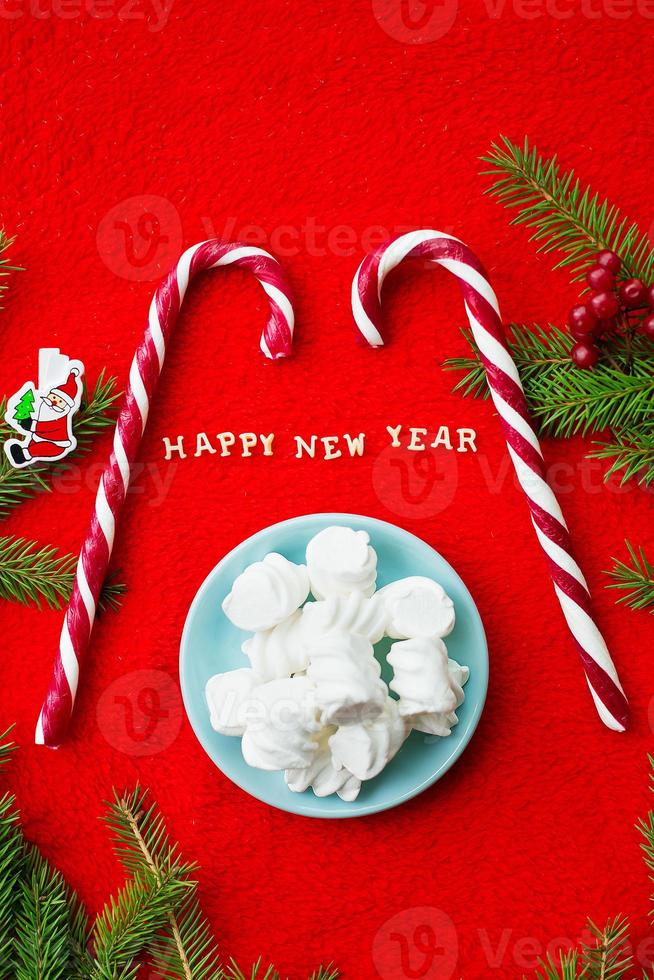 Christmas tree and candy on a red background with the words Happy New Year photo