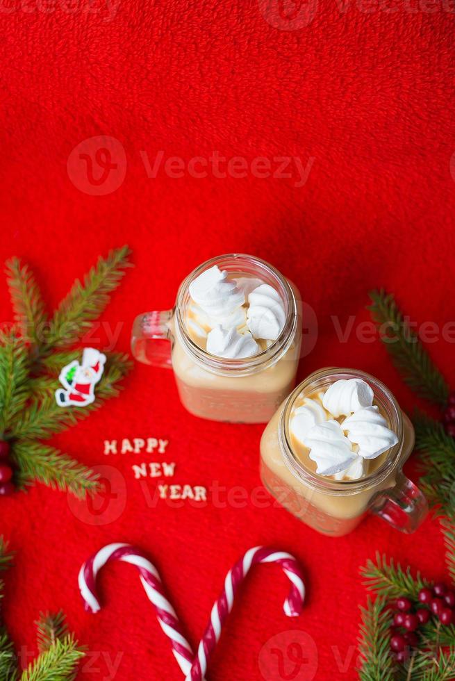 marshmellou cocoa and candy on a red background. The inscription Happy New Year photo