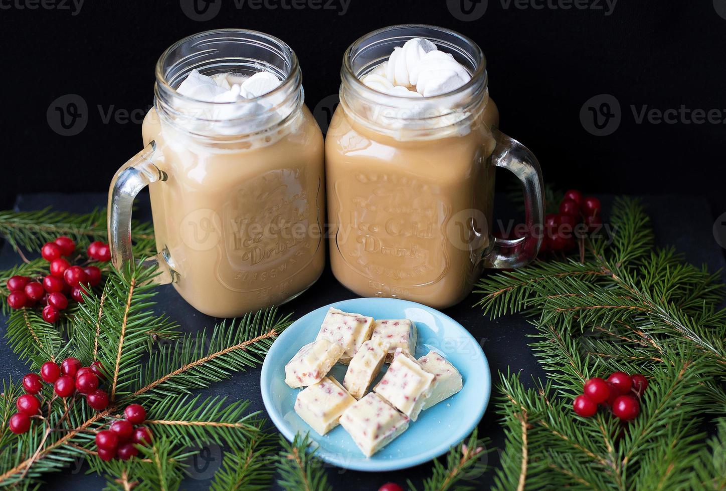 Candies and cocoa with marshmallows on a black background with white chocolate photo