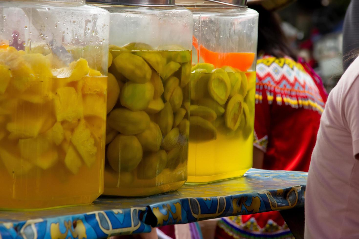 pickles mango and pineapple placed in a jar, selling street vendors photo