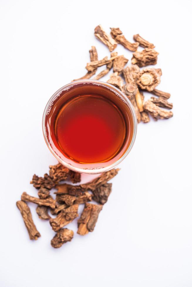 Raw dried Indian Ayurvedic Sarsaparilla, anantmool with Kadha drink or Tea photo