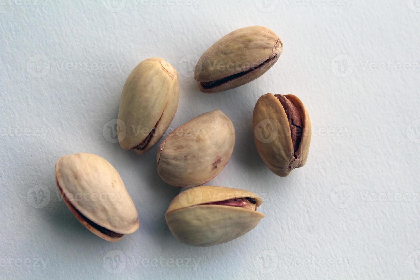 pistachio in shell nuts in a bowl on white background. photo