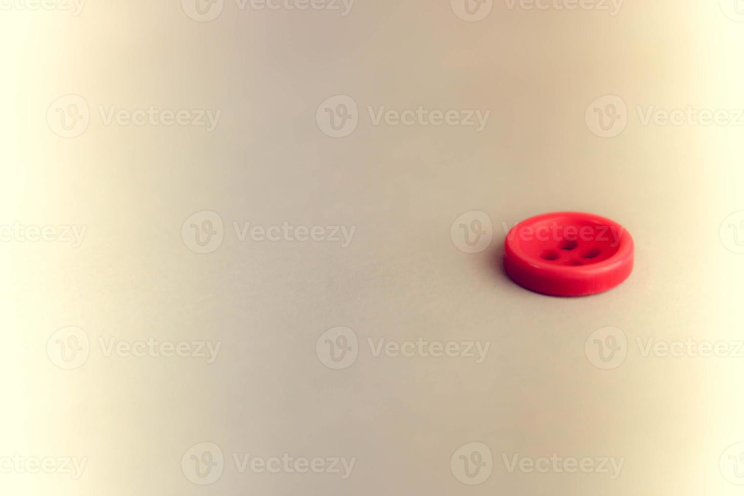 Beautiful texture with a round button for sewing, needlework. Copy space. Flat lay. Blue background photo