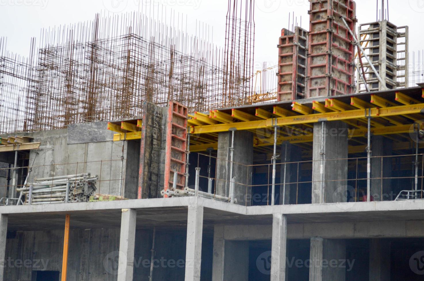 The process of construction and repair of a new modern cement concrete stone pannel monolithic frame-block building of a house with iron reinforcement at an industrial construction site photo