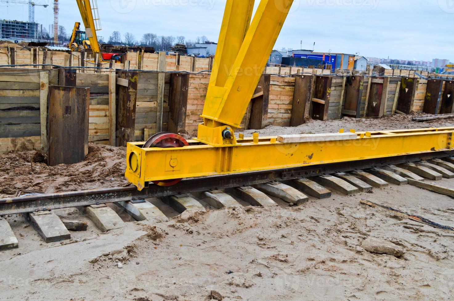 Large iron metal yellow supports on rails with wheels with an induction motor of a large construction stationary industrial powerful gantry crane of a bridge type photo