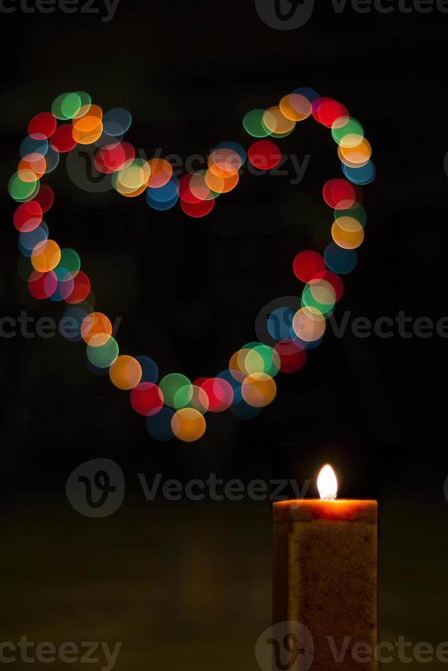 Candles light with bokeh like heart. Abstract candle background. photo