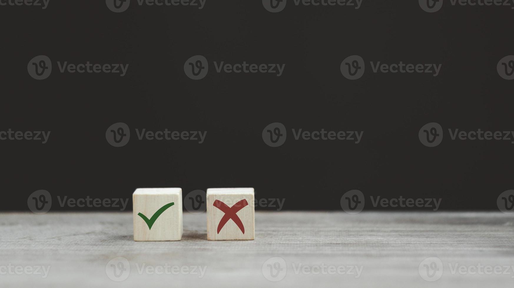 Tick mark and cross mark x on wooden cubes. Wooden blocks with green check mark and red x. Concept of positive or negative decision making or choice of approval or rejection. copy space photo