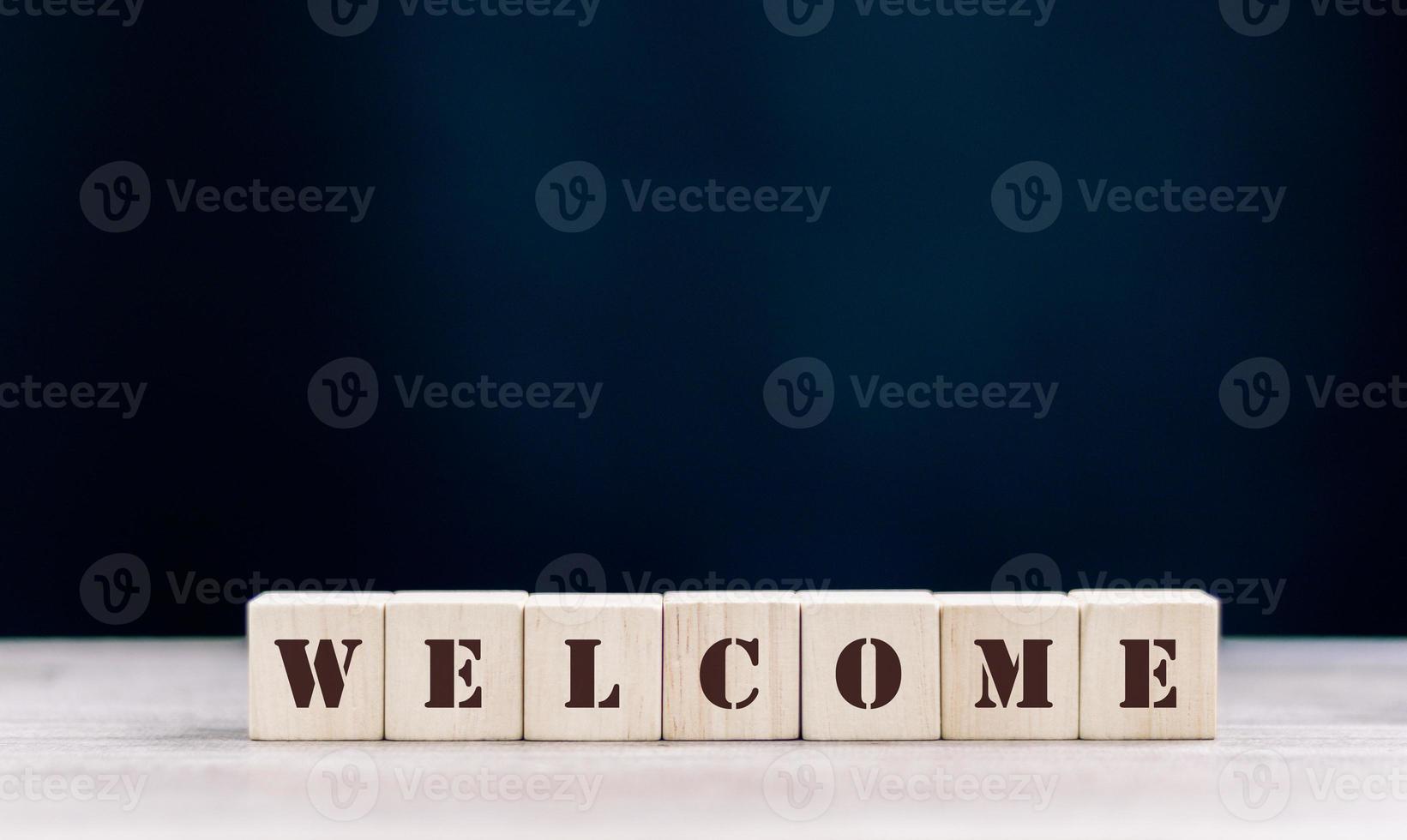the word WELCOME is written on a wooden cubes structure. Cube on a bright background. Can be used for business, MEDICINE, financial concept. Selective focus. photo