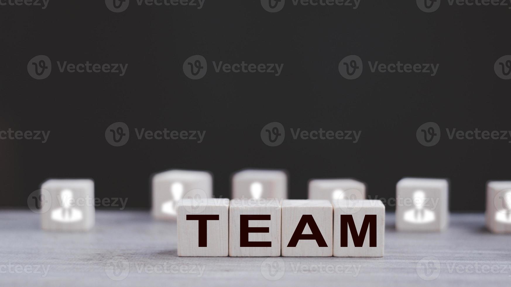 Word team on wooden block, relationship of collaboration and leadership for success, group of community and employee with corporate, teamwork for brainstorming together, no people, business concepts. photo