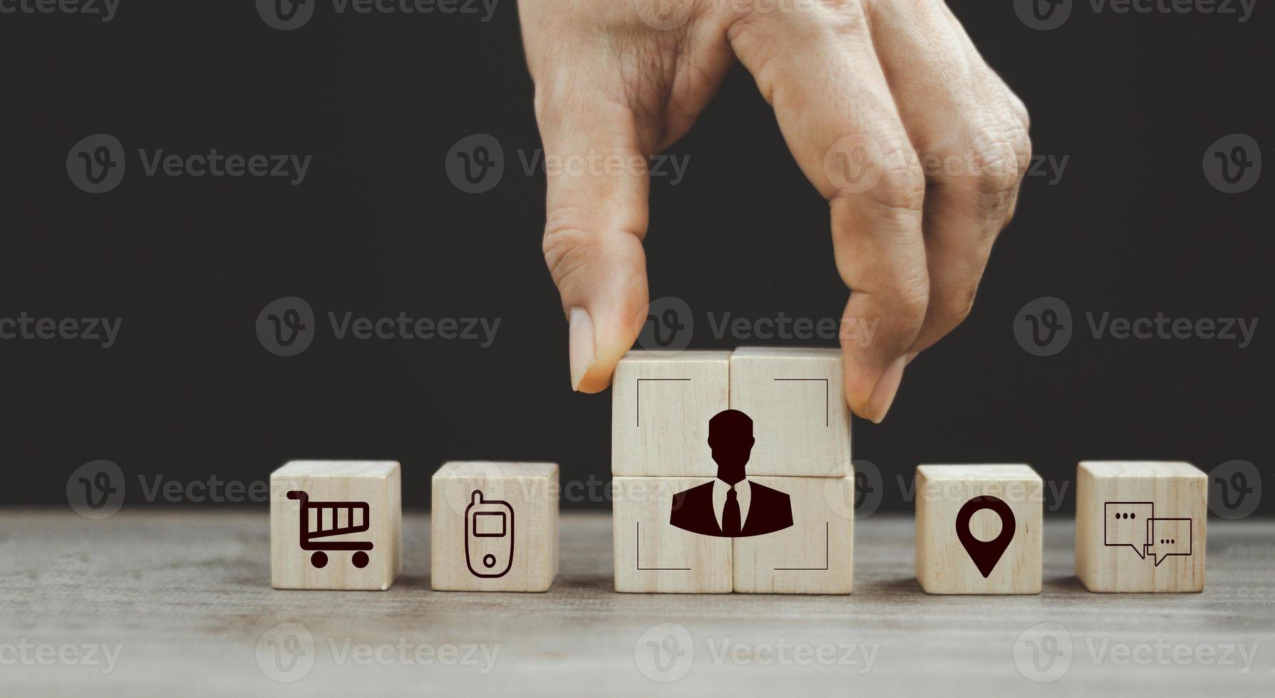senior businessman's hand complete crop icon, people inside on wood cube for Buyer persona and target customer concept. Buyer or customer psychology profile or characteristics photo