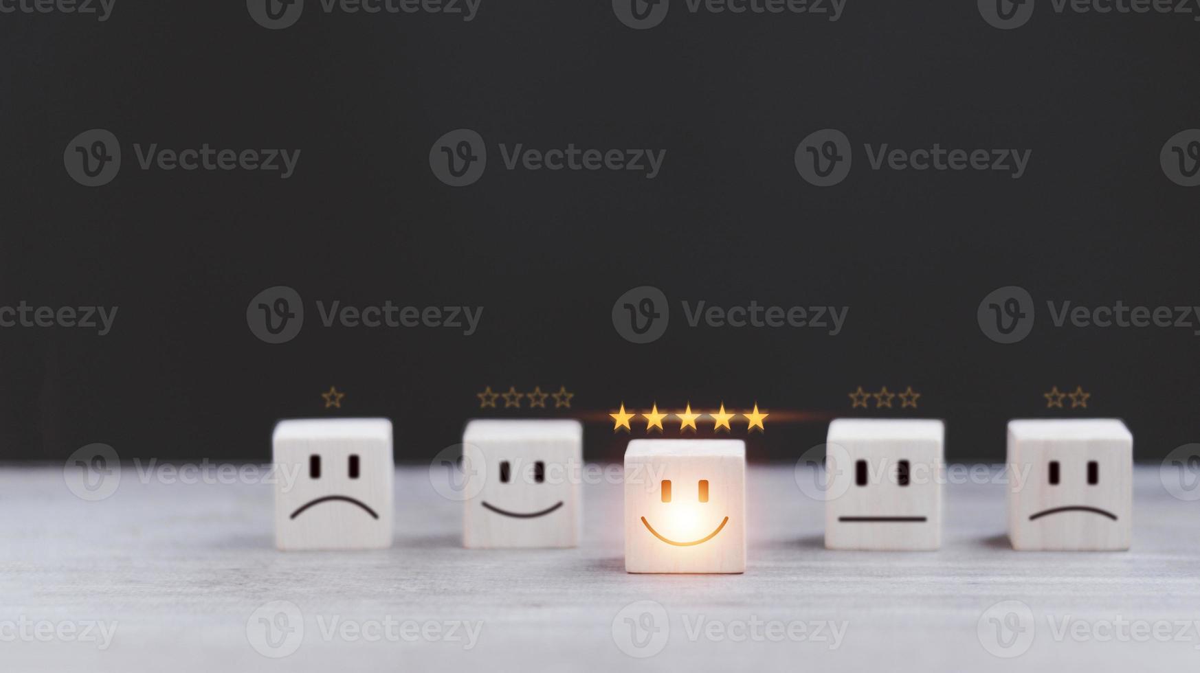 customer services best excellent business rating experience. Satisfaction survey concept. Hand of a businessman chooses a smiley face on wood block cube. 5 Star Satisfaction photo