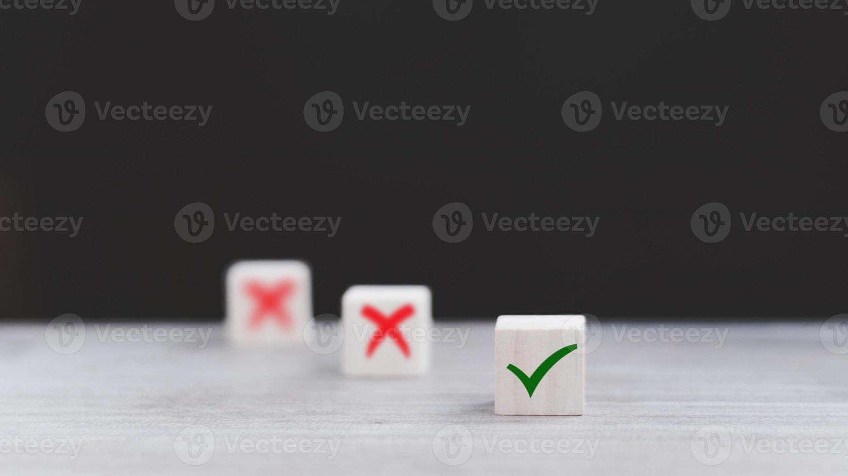 Tick mark and cross mark x on wooden cubes. Wooden blocks with green check mark and red x. Concept of positive or negative decision making or choice of approval or rejection. copy space photo