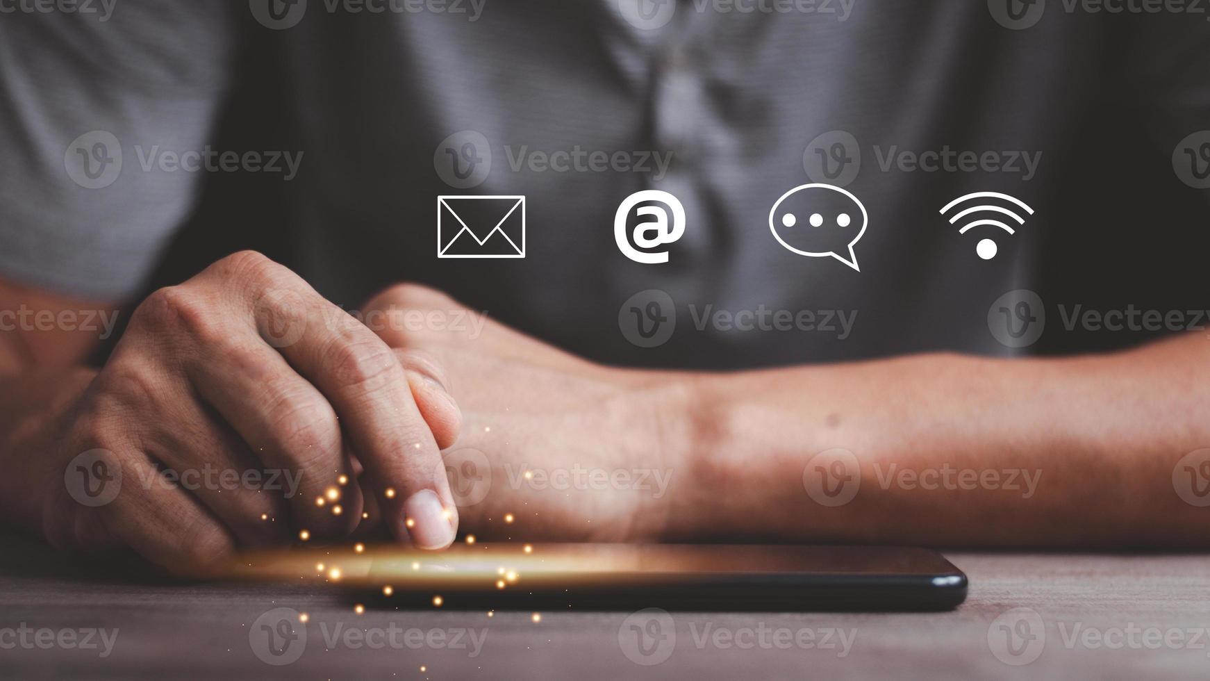 Customer support hotline Contact us people connection. Businessman using Smart Phone with the email, call phone, address, Chat message icons. photo