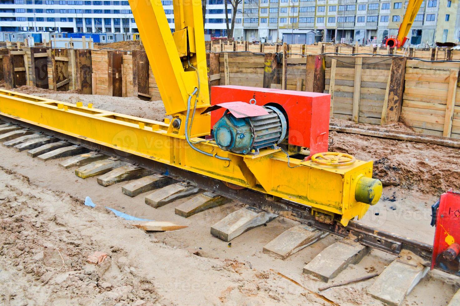 Large iron metal yellow supports on rails with wheels with an induction motor of a large construction stationary industrial powerful gantry crane of a bridge type photo